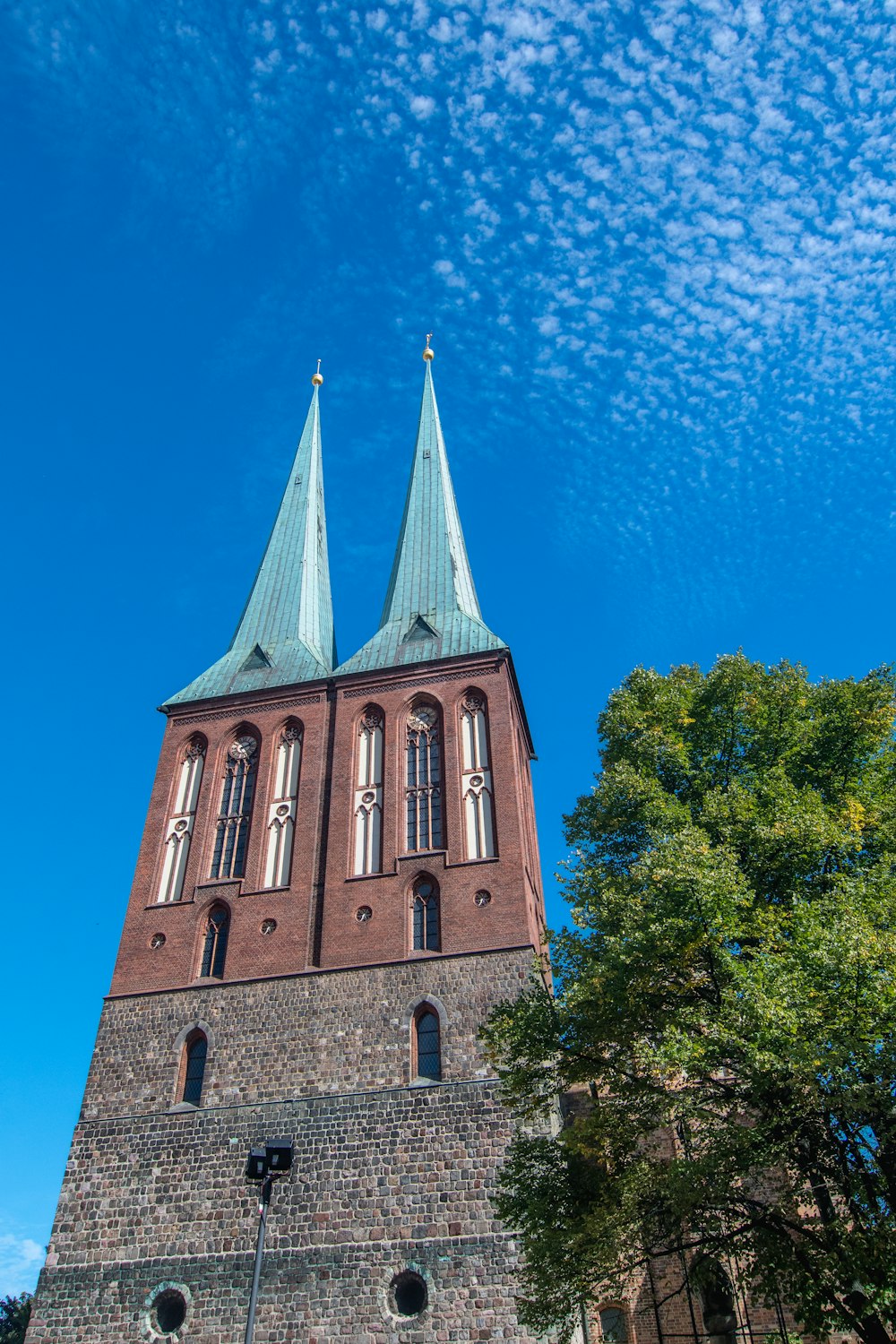 a tall brick building with two towers on top of it