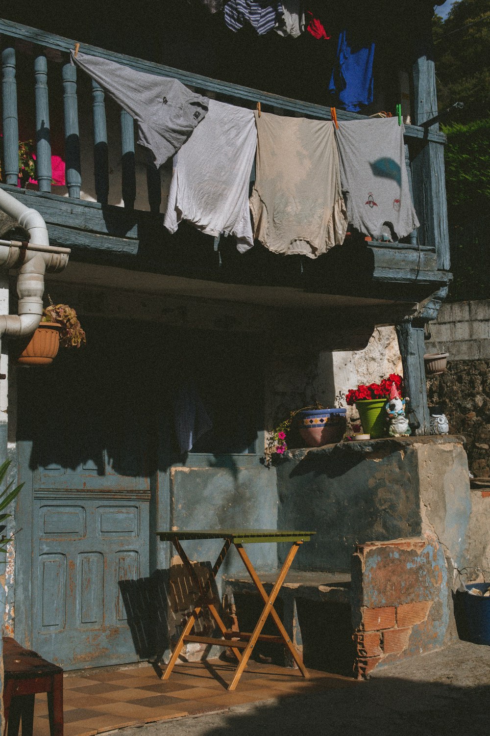 clothes hanging on a clothes line outside of a house