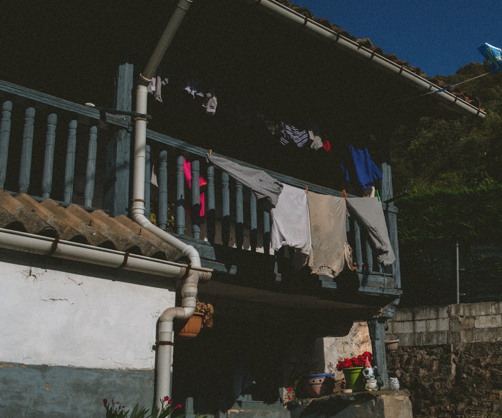 clothes hanging on a clothes line outside of a house