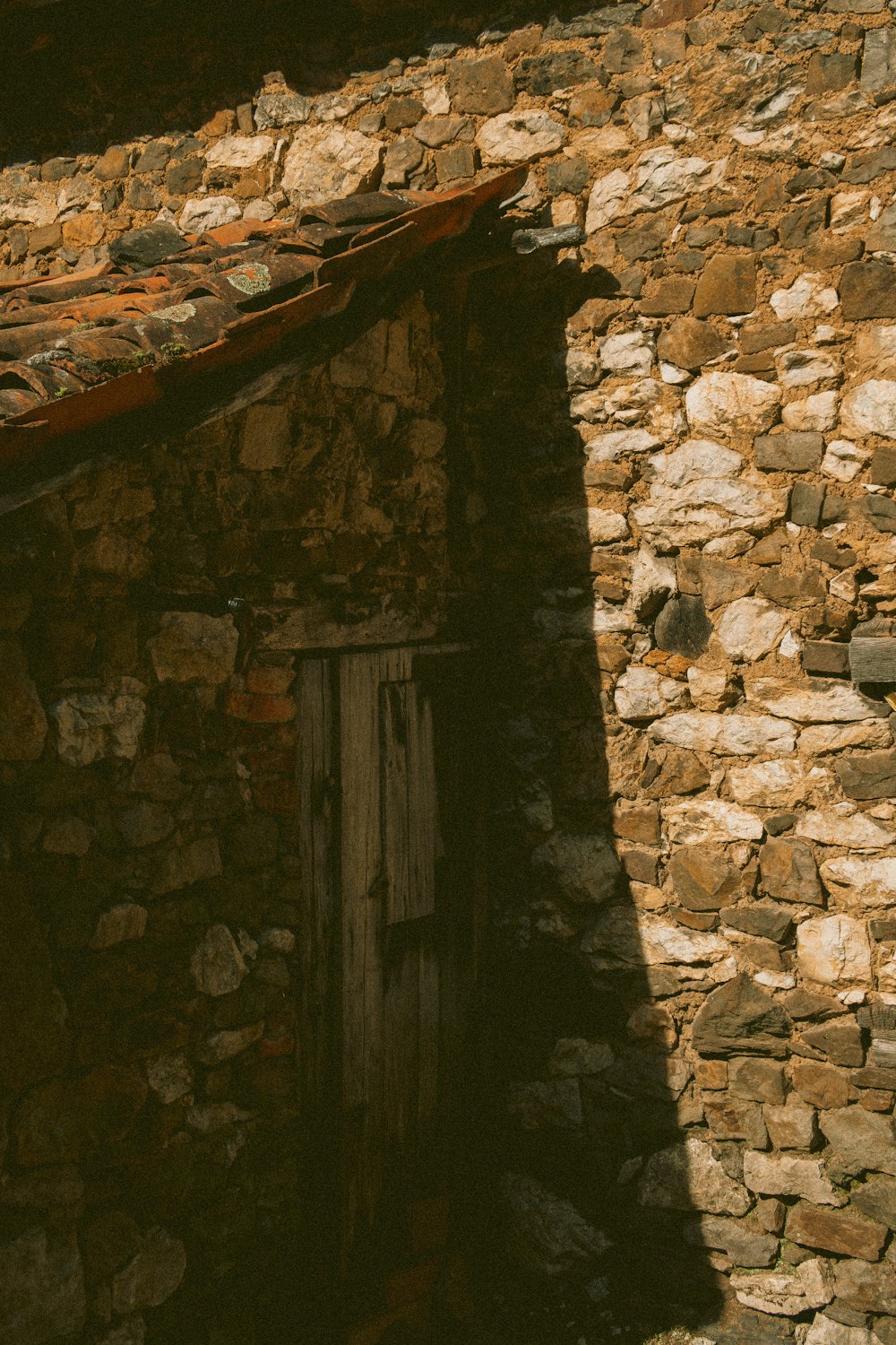 a stone building with a door and a window