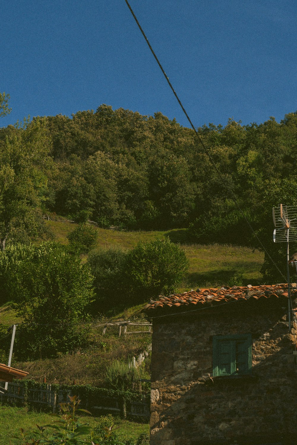 a house on a hill with a ski lift in the background