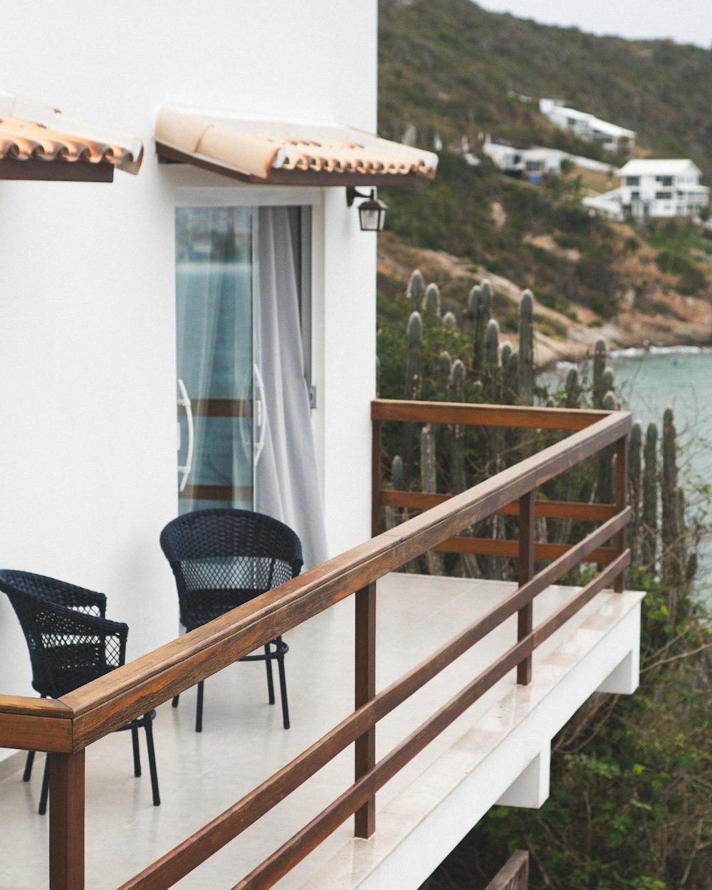 a couple of chairs sitting on top of a balcony