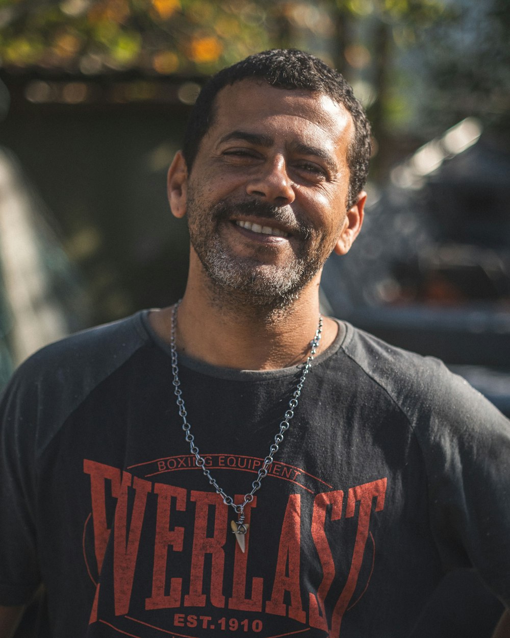 a man wearing a black shirt and smiling