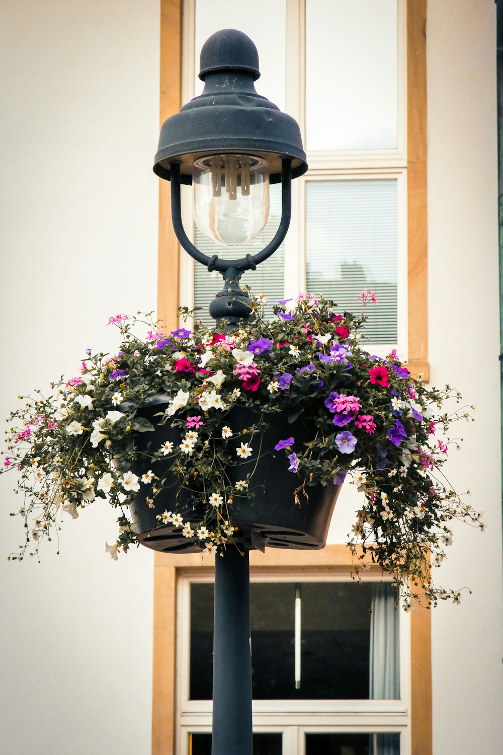 a lamp post with a flower box on top of it