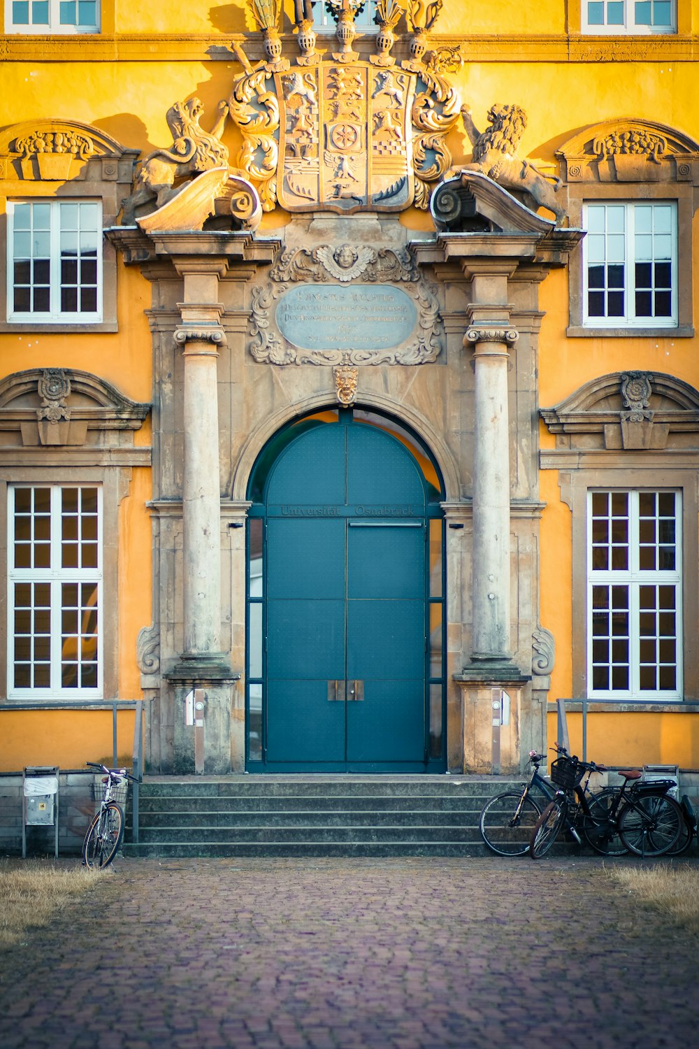 a large yellow building with a blue door