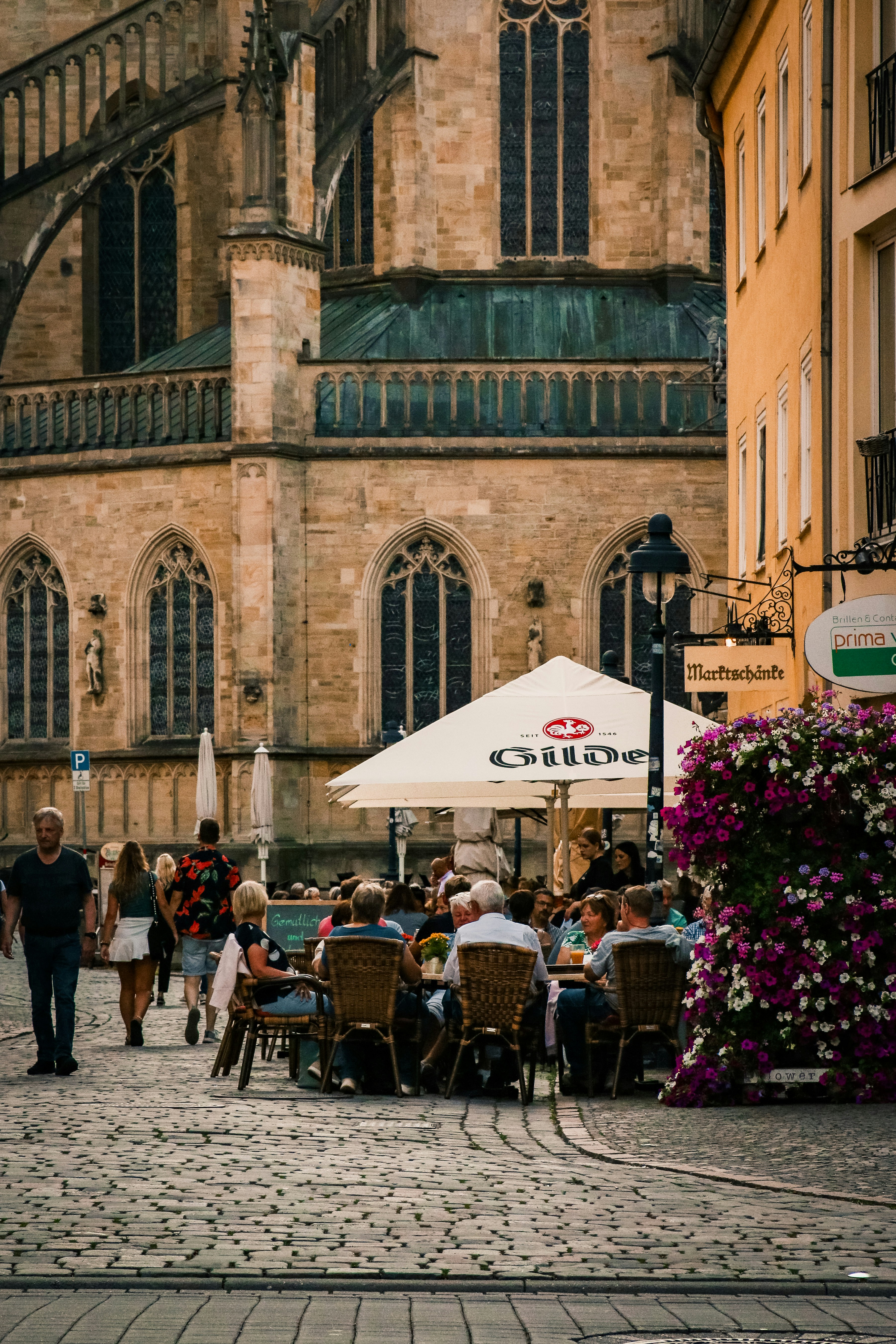 a group of people sitting at tables in front of a building