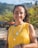 a woman in a yellow shirt is smiling