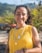 a woman in a yellow shirt is smiling