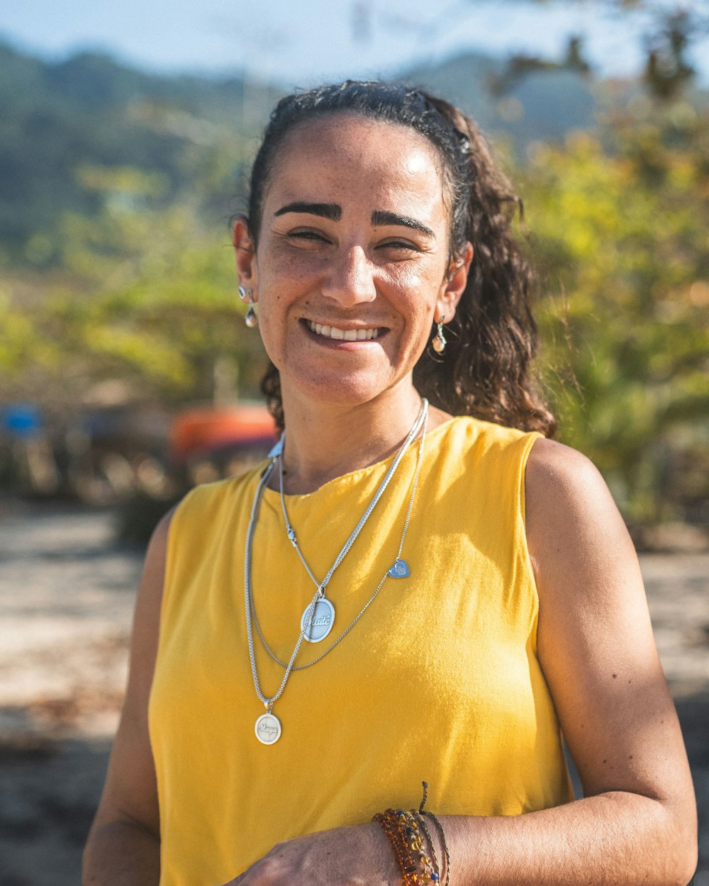 a woman in a yellow shirt is smiling