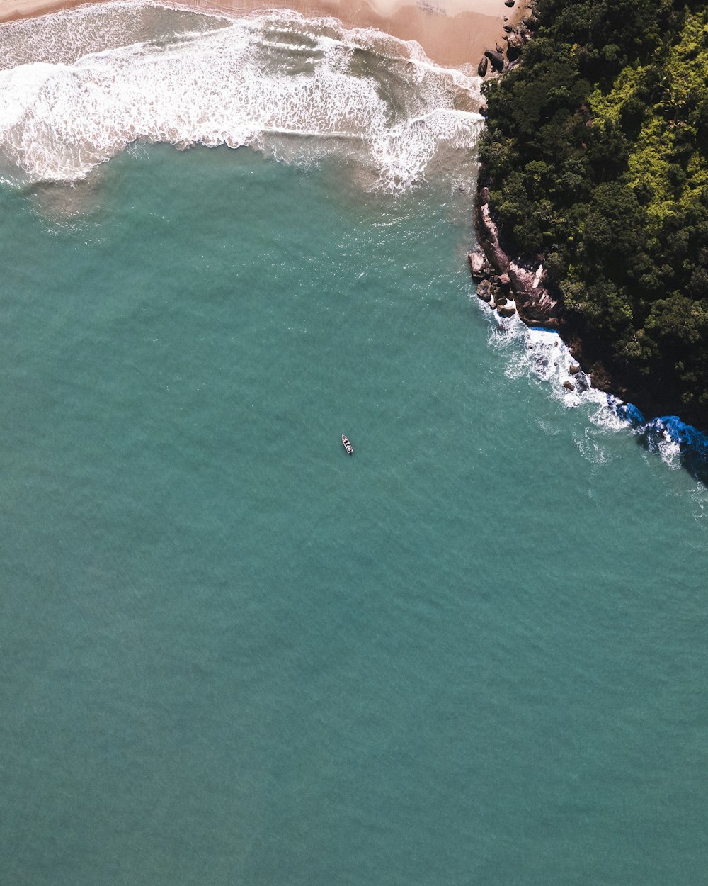 an aerial view of a body of water and a beach