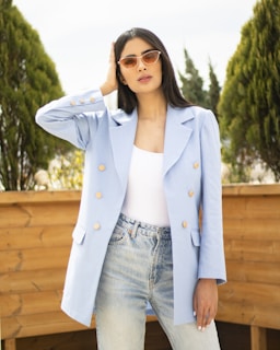 Side profile of a model wearing a modern, structured blazer paired with casual jeans