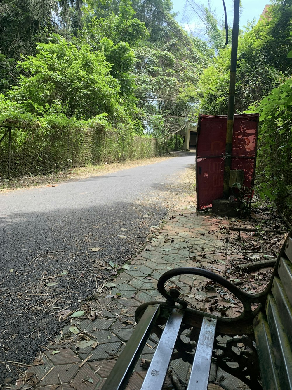 a park bench sitting on the side of a road