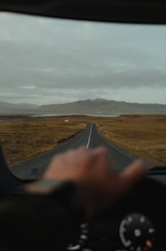 a person driving a car down a rural road