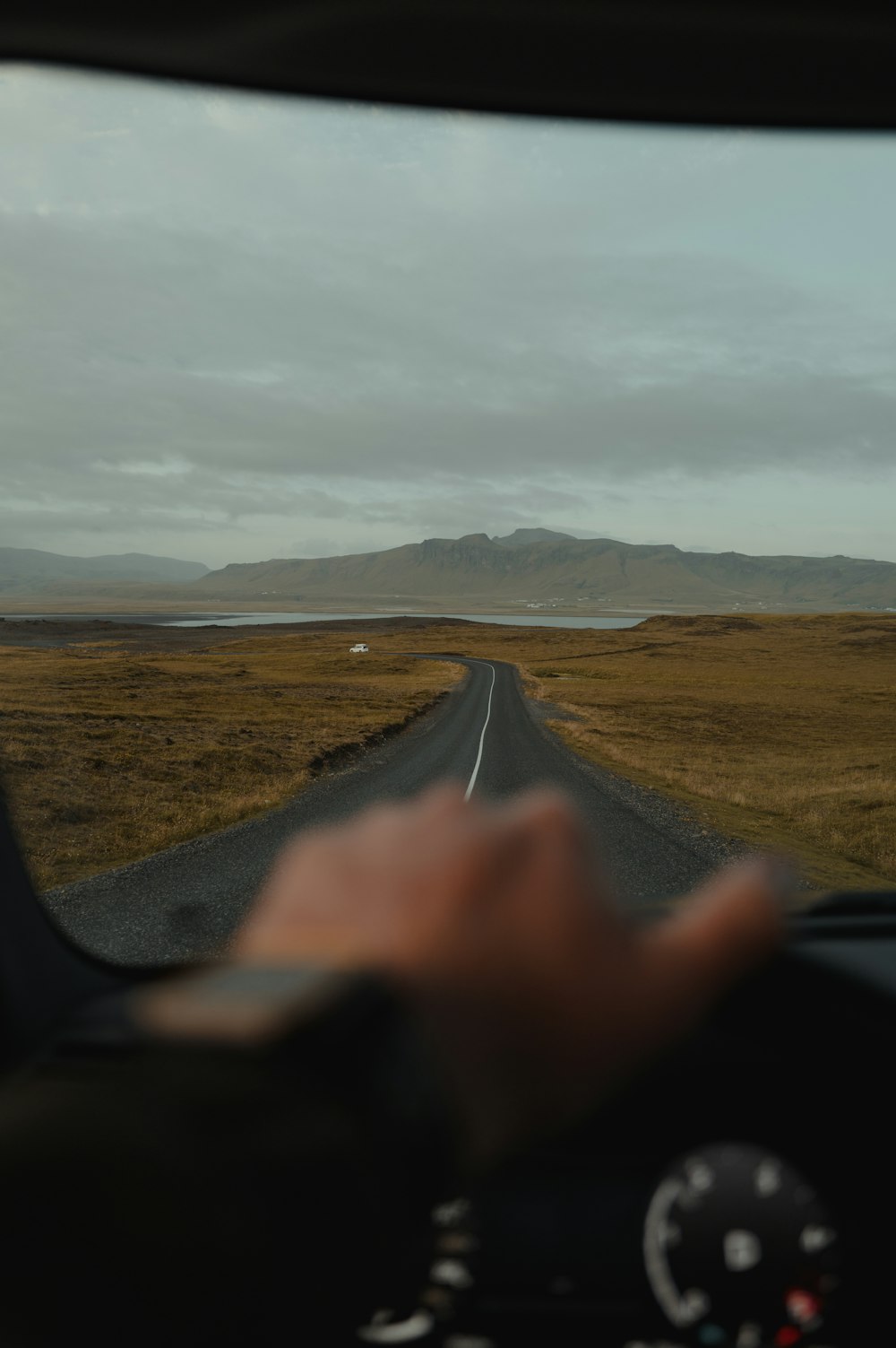 a person driving a car down a rural road