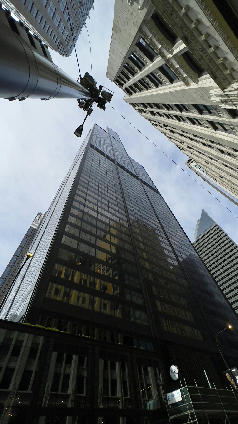 looking up at a tall skyscraper in the city