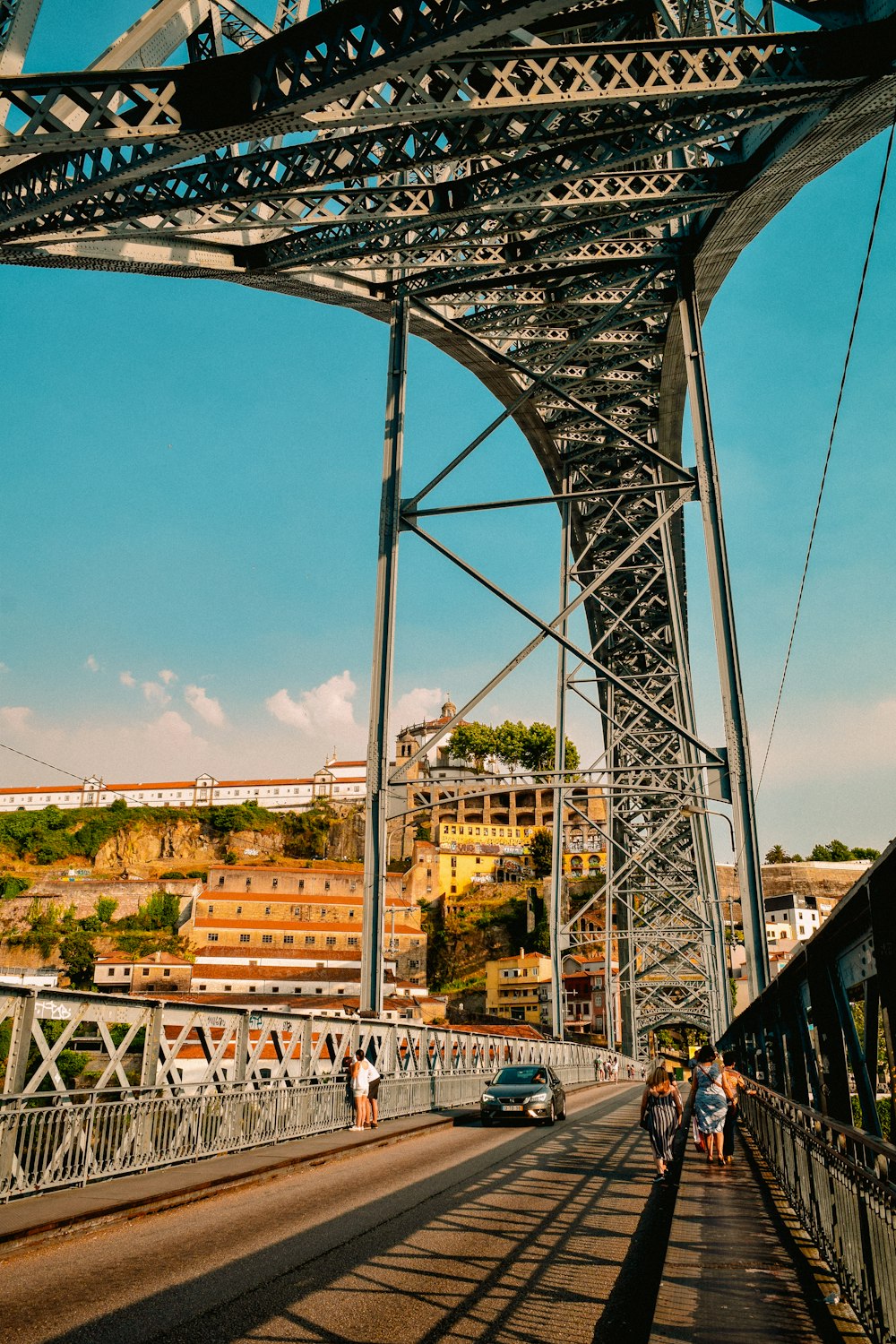 a group of people walking across a bridge