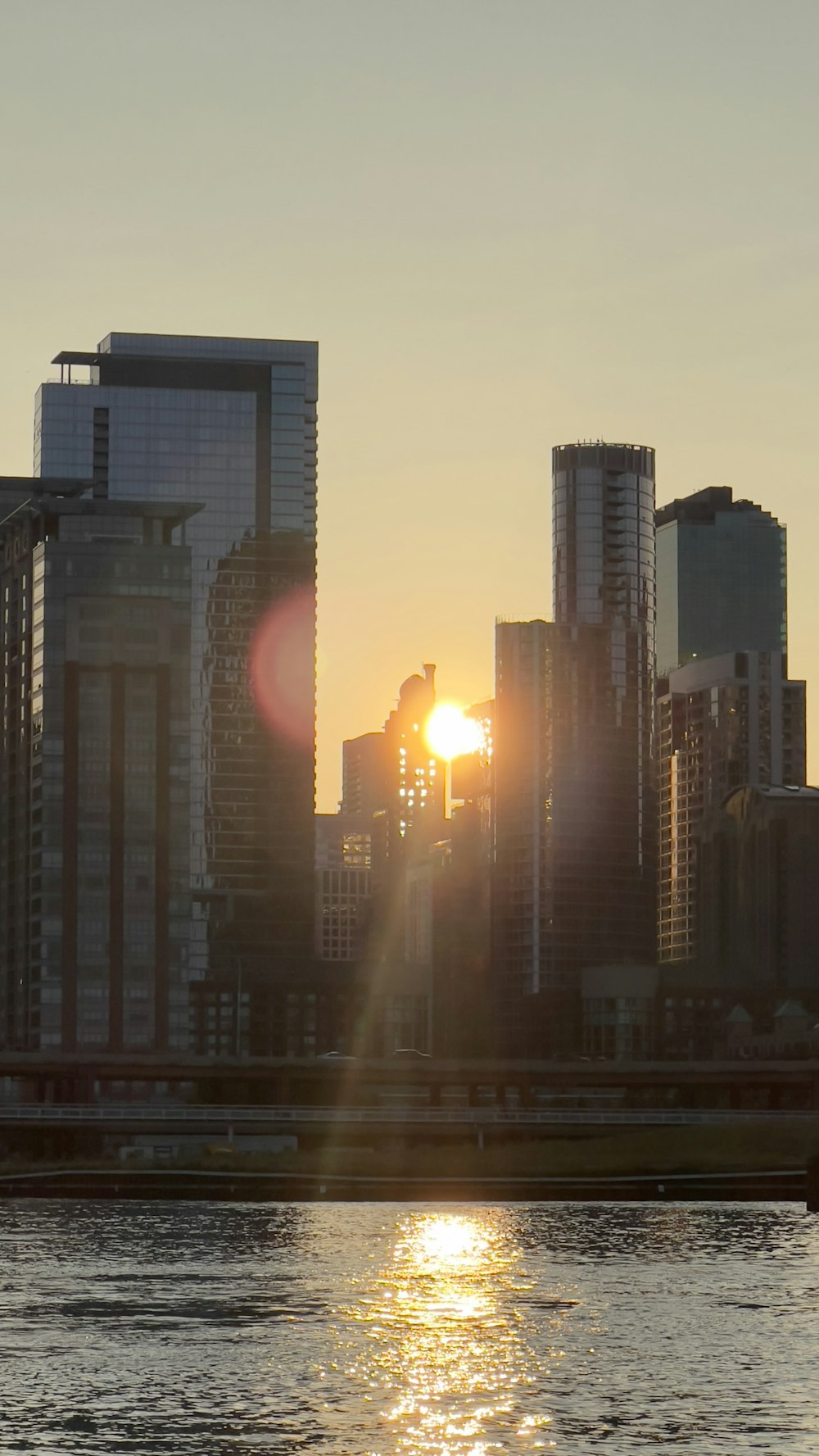 the sun is setting over the city skyline