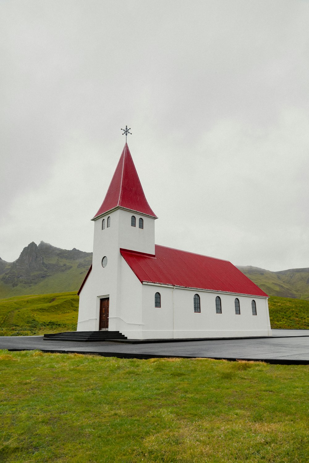 a small white church with a red roof