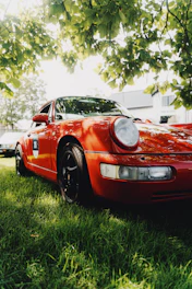 a red sports car parked in the grass