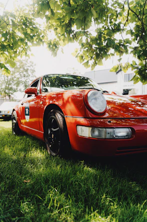 a red sports car parked in the grass