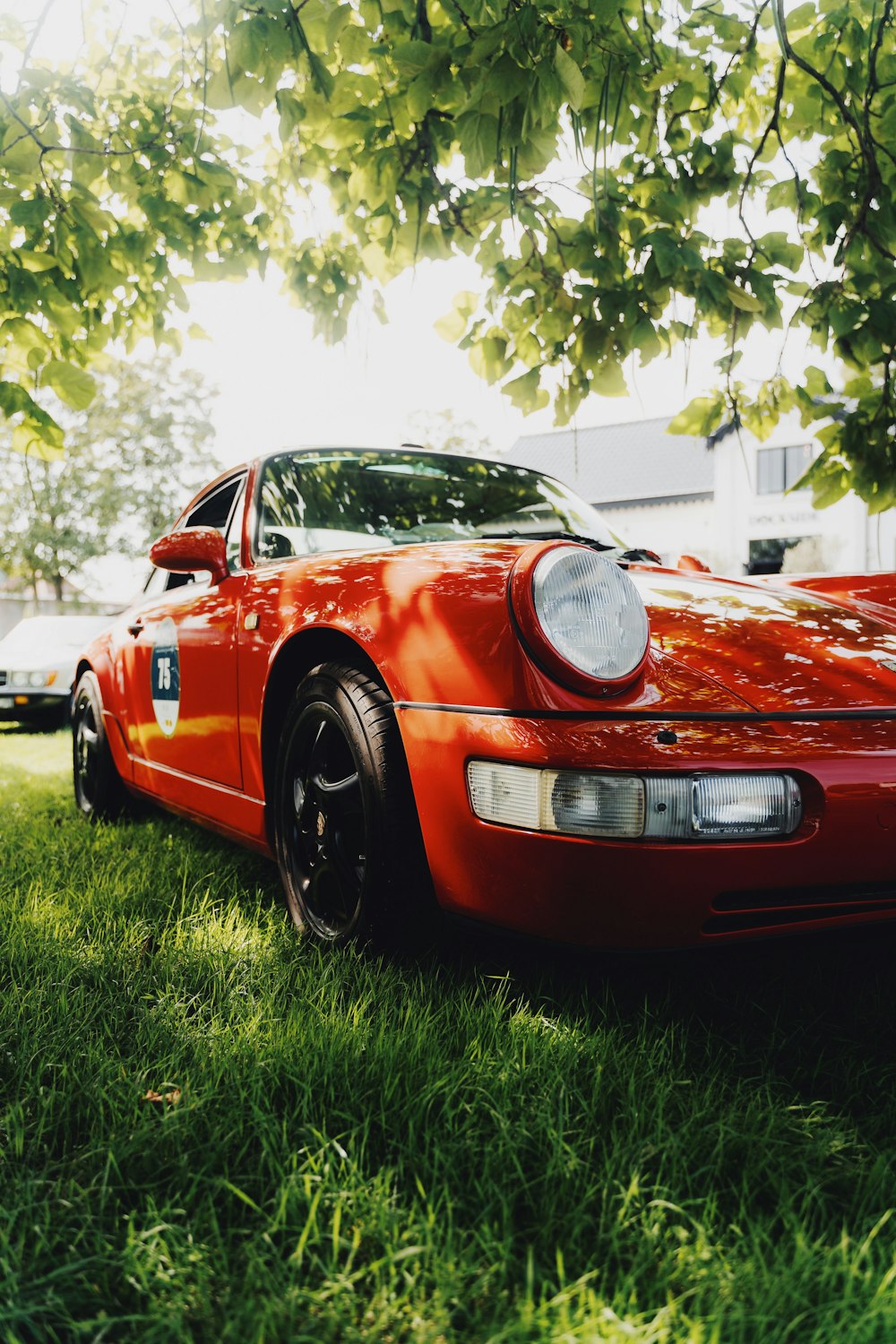 a red sports car parked in the grass