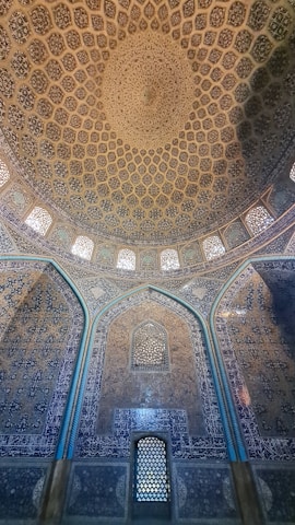 Close-up of intricate mosque decorations with yellow tones