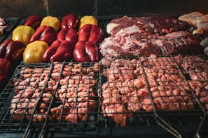 Close-up of a sizzling street food grill with colorful vegetables and meats cooking
