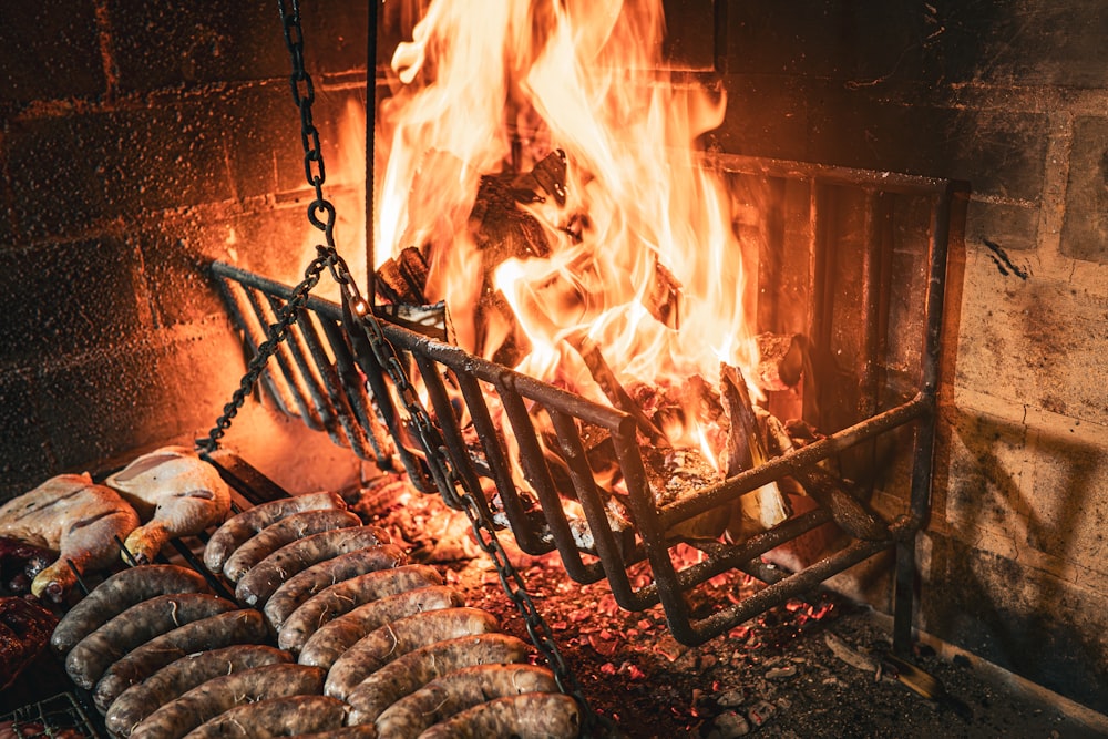 a fire burning in a fireplace with lots of food