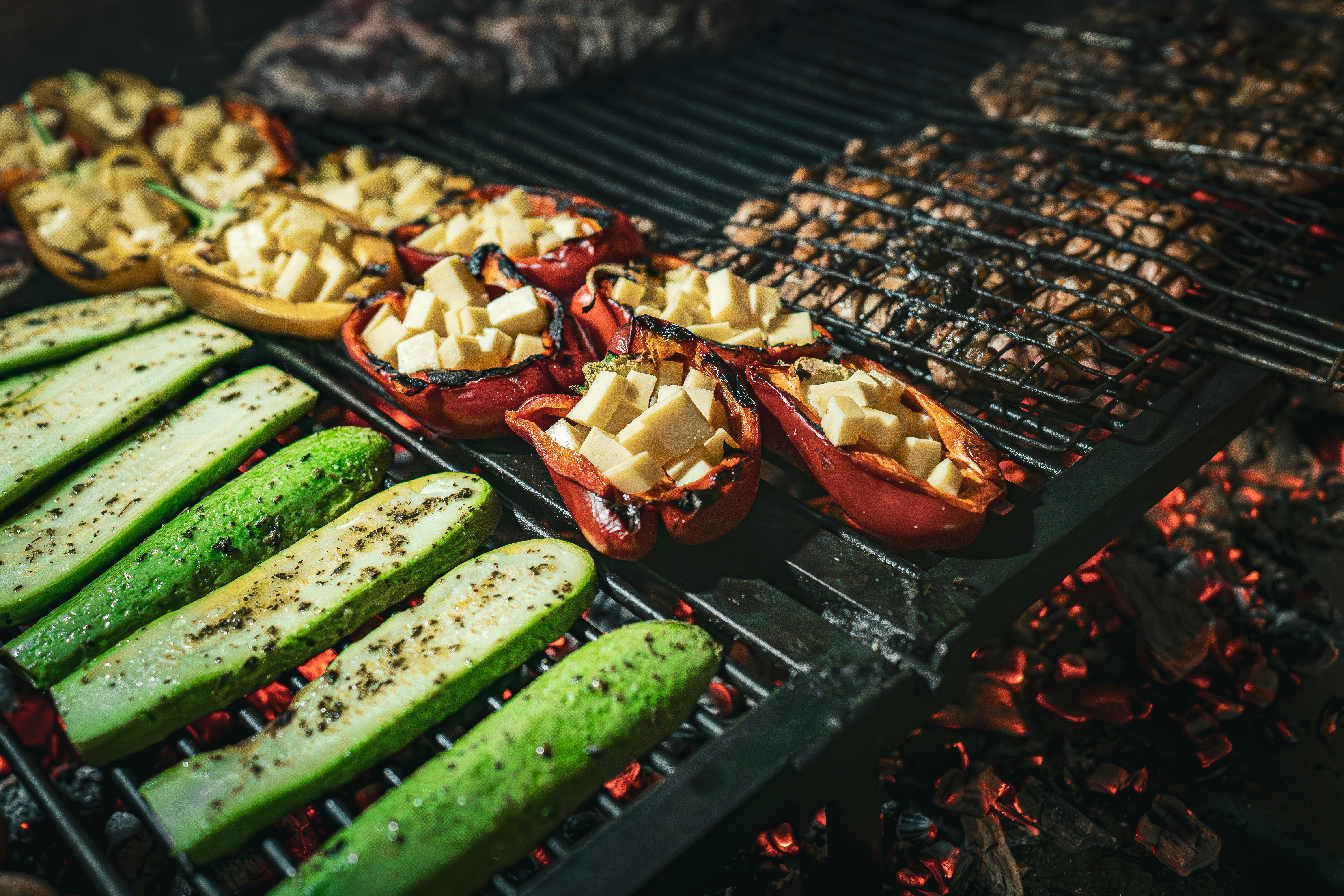 a grill with several different types of food cooking on it, Meat roasted on the grill