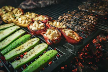 a grill with several different types of food cooking on it