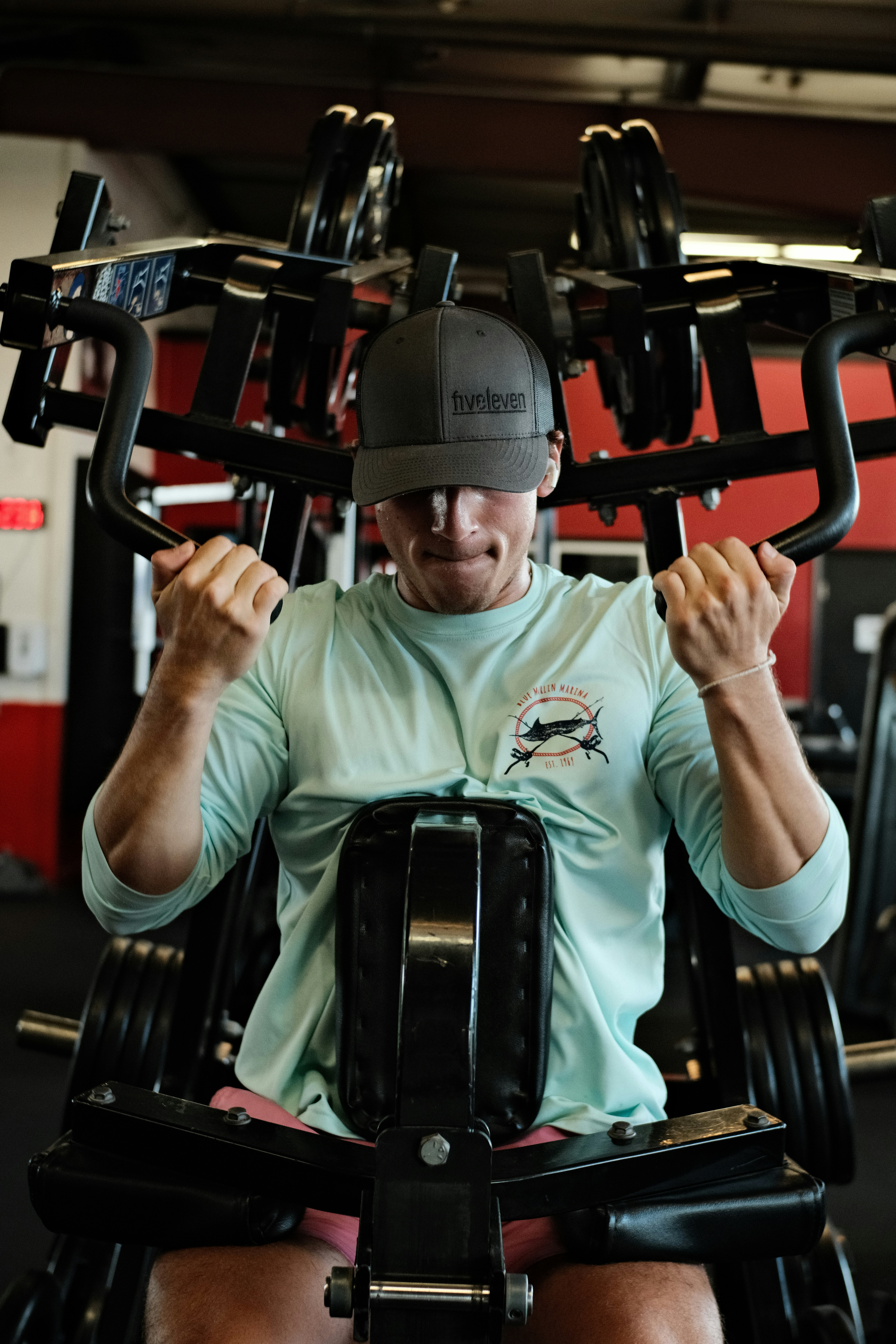 a man sitting on a bench in a gym