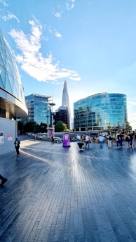 Mo Aboshanab speaking with local residents at a community event in Canary Wharf, with the skyline in the background.