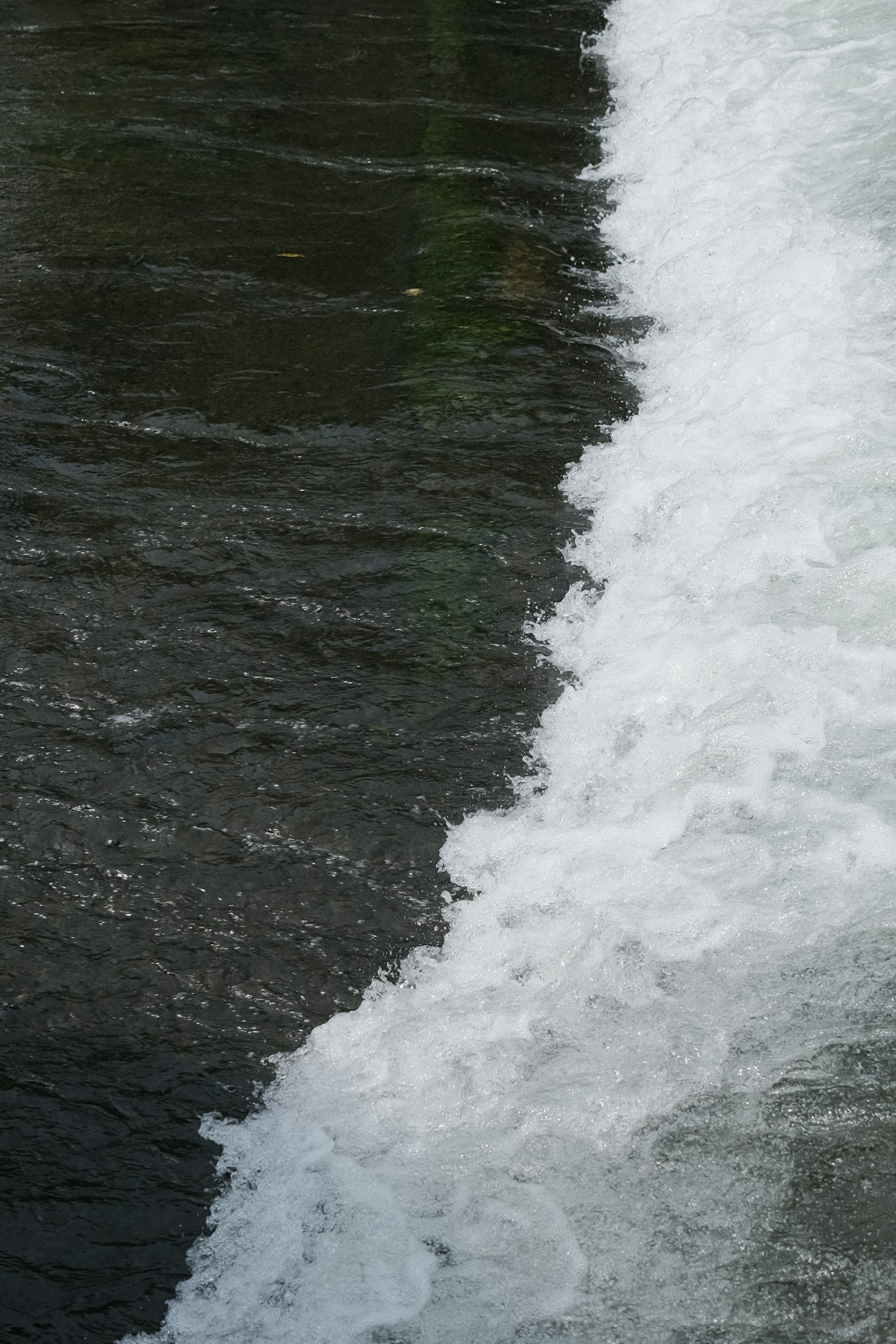 a man riding a surfboard on top of a wave