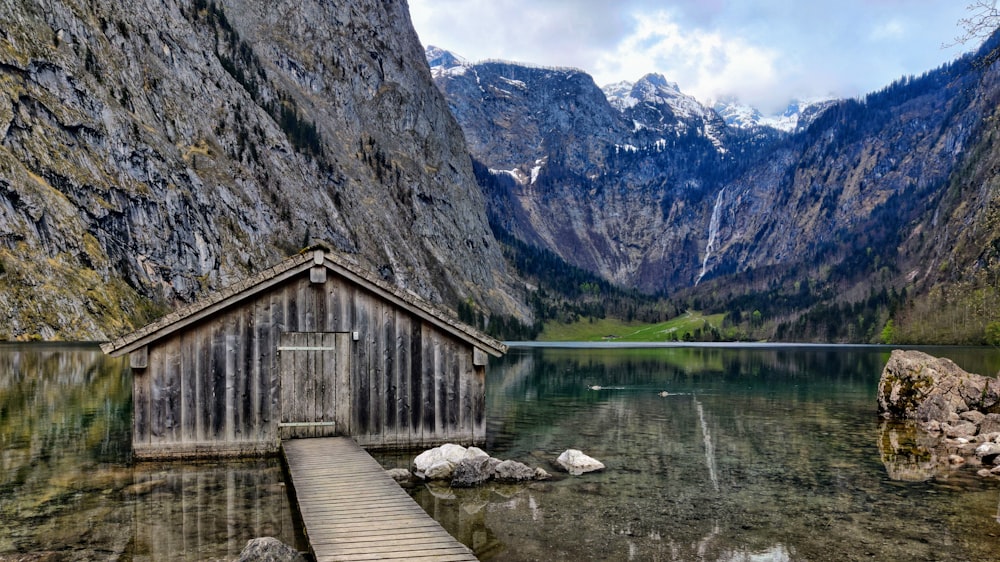 a wooden dock sitting next to a mountain lake