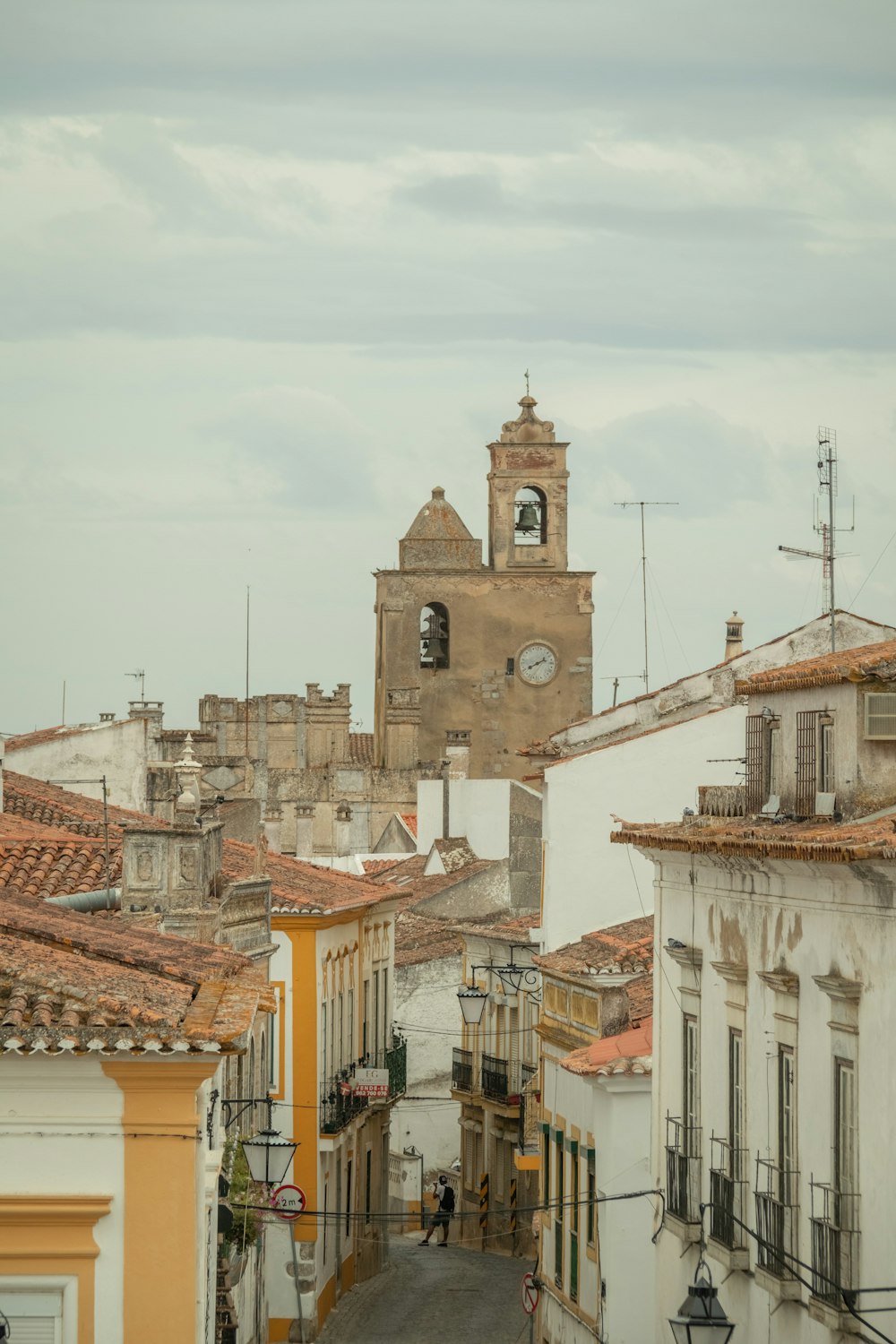 a street with buildings and a clock tower in the background