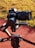 A high-end Sony camera mounted on a DJI Ronin gimbal, positioned outdoors on a track or pathway with grass in the background. The camera setup suggests professional-grade equipment used for capturing high-quality images or videos.