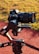 A high-end Sony camera mounted on a DJI Ronin gimbal, positioned outdoors on a track or pathway with grass in the background. The camera setup suggests professional-grade equipment used for capturing high-quality images or videos.