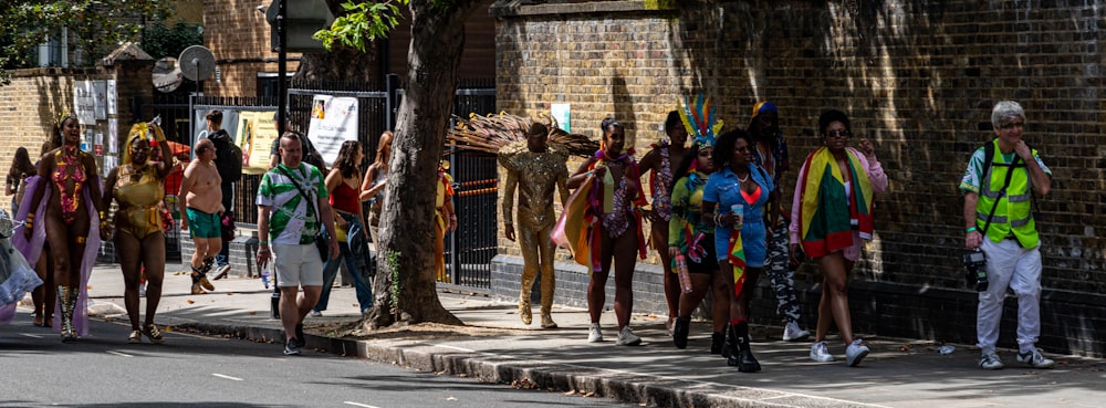 a group of people standing on the side of a road