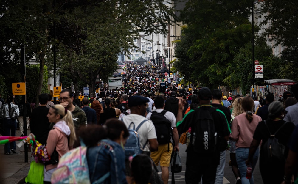 a large group of people walking down a street