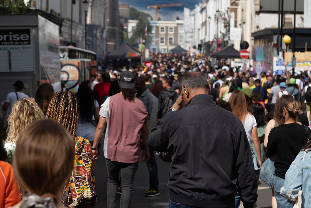 a crowd of people walking down a street
