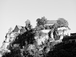 A scenic view of a historic building surrounded by nature.