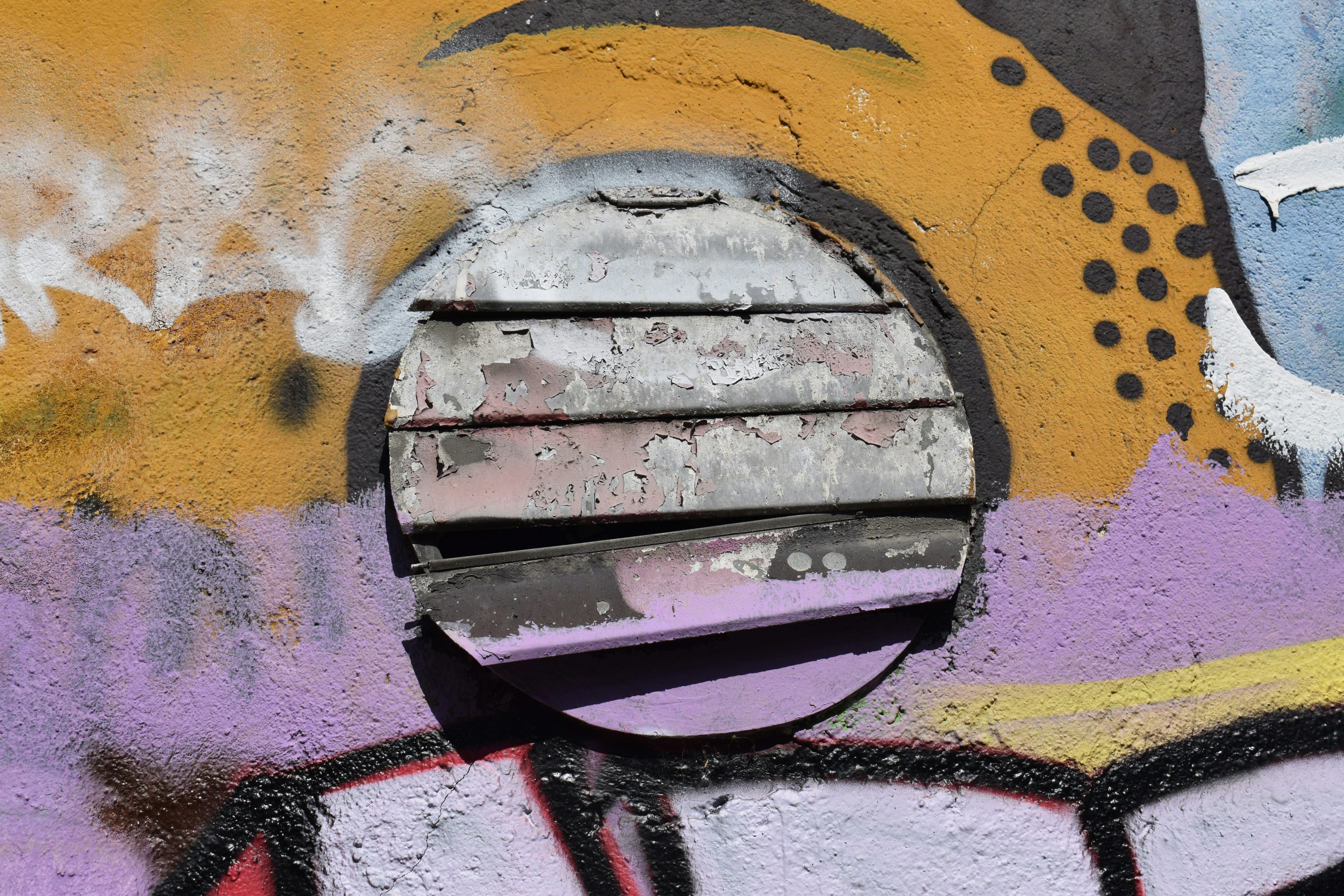 a close up of a wall with graffiti on it