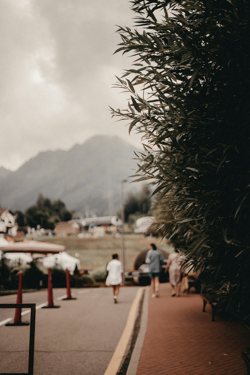 a couple of people that are walking down a street