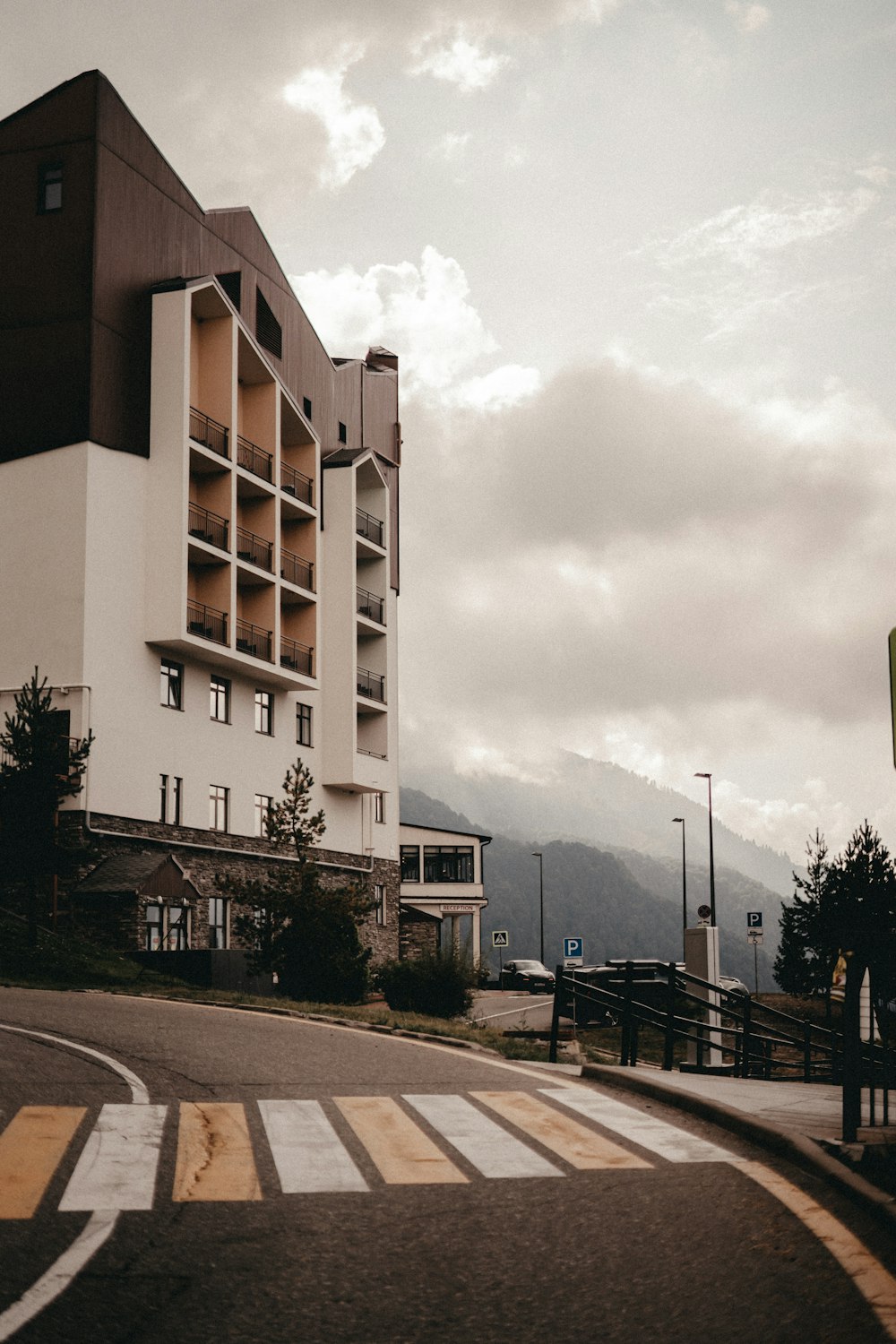 a tall white building sitting on the side of a road