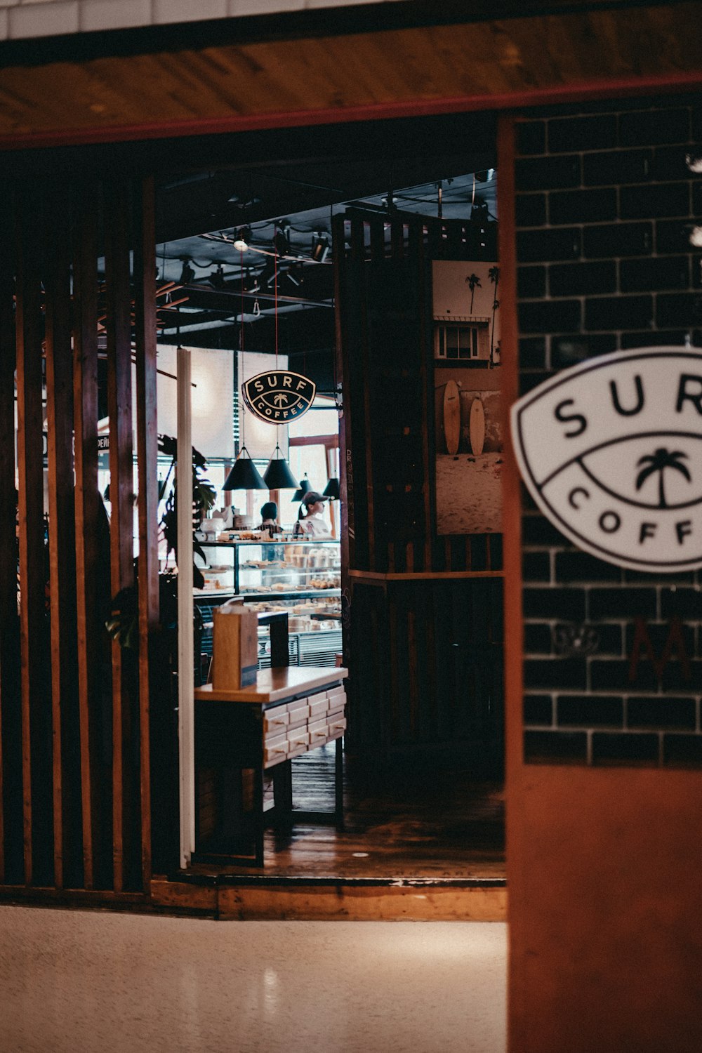 the entrance to a coffee shop with a brick wall