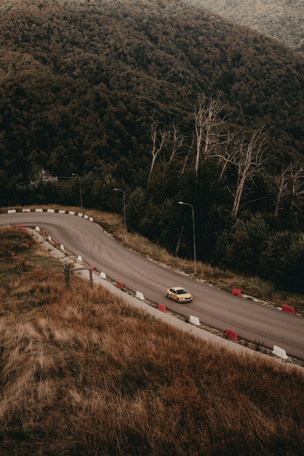 a car driving down a winding road in the mountains