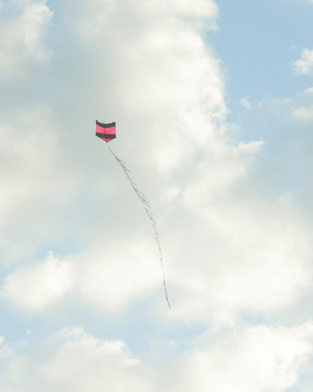 a kite is flying high in the sky