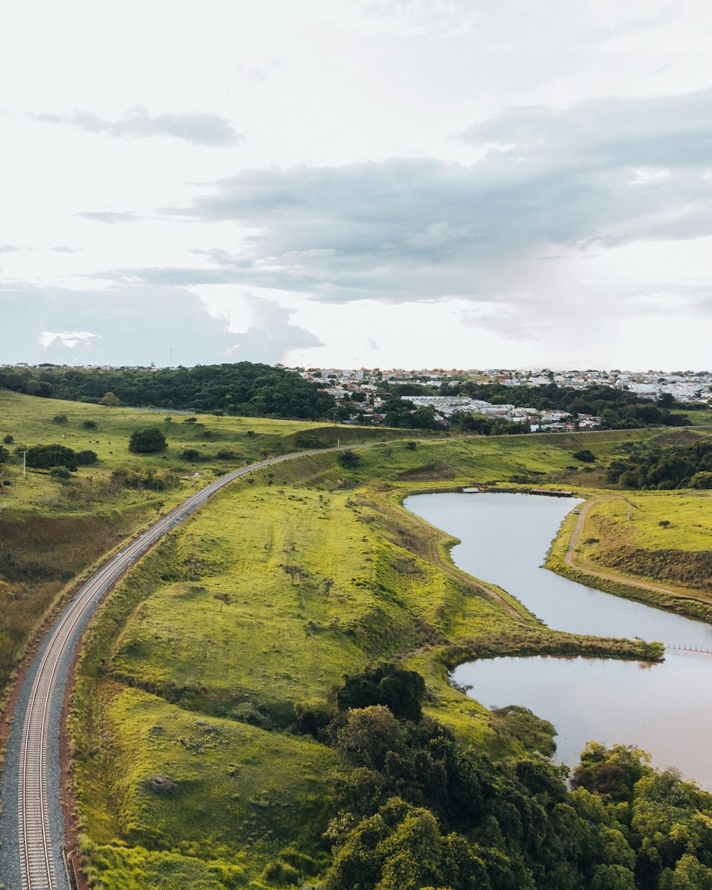 an aerial view of a winding road and a river