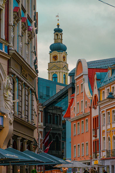 a group of people walking down a street next to tall buildings