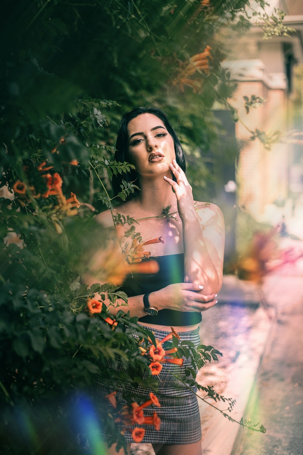 a woman standing in front of some flowers